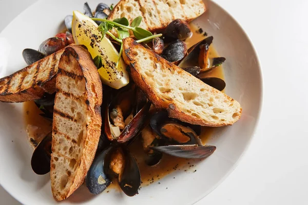 Fruits de mer. Moules dans le vin avec croûtons et citron. Palourdes dans les coquilles . — Photo