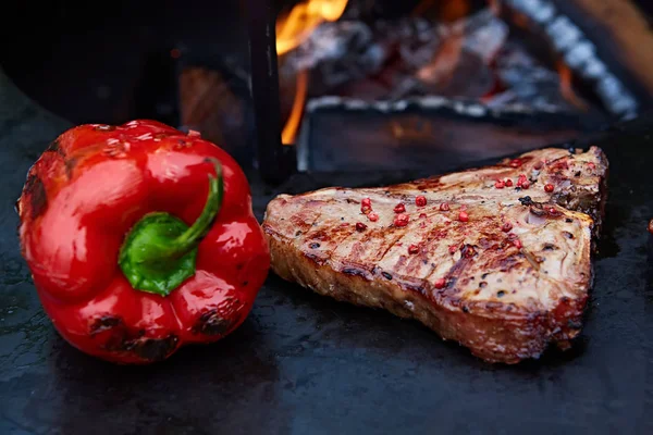 Grilled T-Bone Steak on serving board on wooden background — Stock Photo, Image