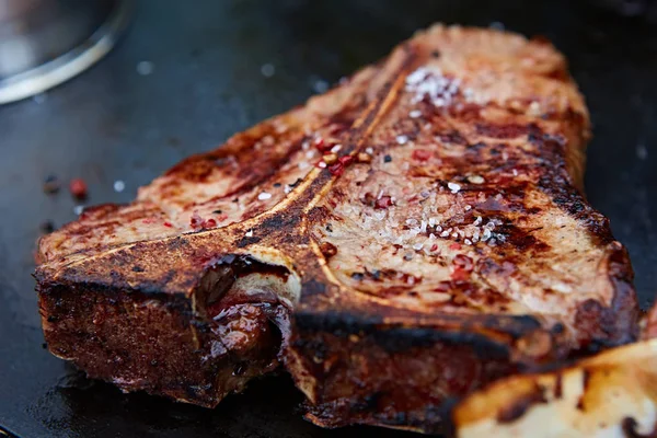 Kurul üzerinde ahşap arka plan hizmet üzerinde ızgara T-Bone biftek — Stok fotoğraf