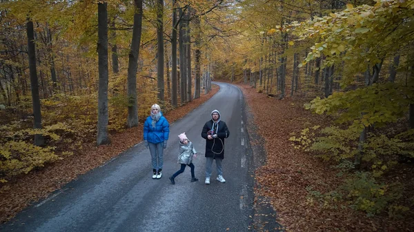Family portrait in the autumn forest. Shooting from the drone — Stock Photo, Image