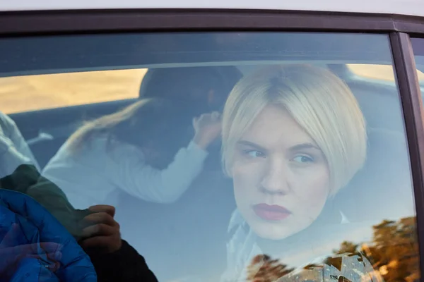 Family concept. Portrait of mother and daughter through the glass of a car — Stock Photo, Image