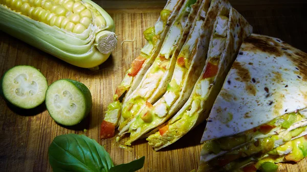 Mexican quesadilla with chicken, cheese and peppers on wooden table — Stock Photo, Image