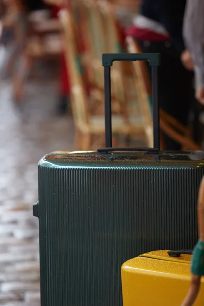 Luggage bag on the city street ready to pick by airport transfer taxi car. — Stock Photo, Image