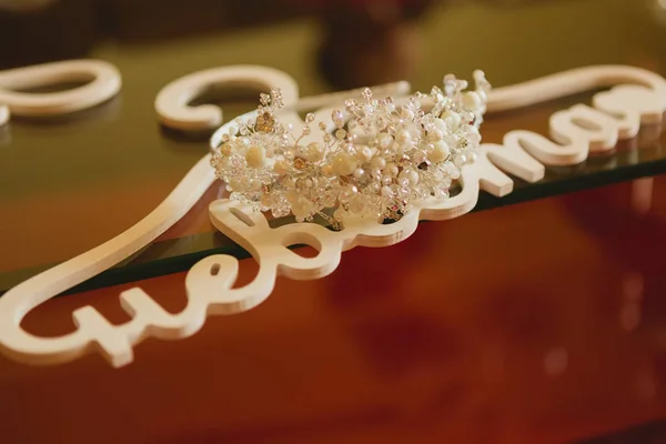 The composition of beautiful wedding accessories bride and word bride on hangers. — Stock Photo, Image