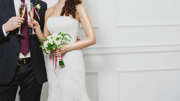 Элегантная невеста и жених позируют вместе в студии в день свадьбы . — стоковое фото