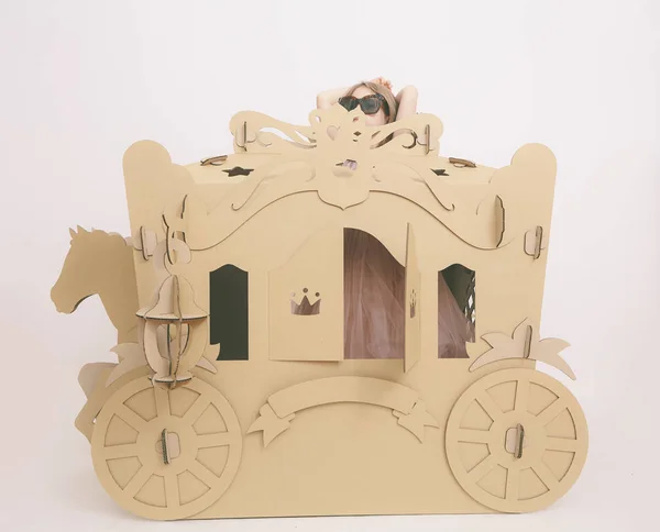 Cute Little Caucasian Girl in Pastel Pink Dress Princess Preparing for Birthday Party and posing in fairy tale carriage. — Stock Photo, Image