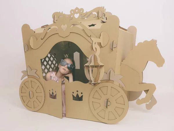 Cute Little Caucasian Girl in Pastel Pink Dress Princess Preparing for Birthday Party and posing in fairy tale carriage. — Stock Photo, Image