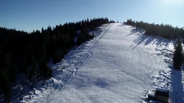 冬のスキー リゾートでスキー エレベーターと空中風景の雪の斜面。高級スキー リゾート ドローン ビューの冬の活動 — ストック動画