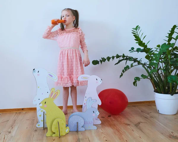 Easter 2019 Beautiful little girl in a dress with Easter decorations. Big Easter bunnies. A lot of different colorful Easter decor. Multicolored decor — Stock Photo, Image