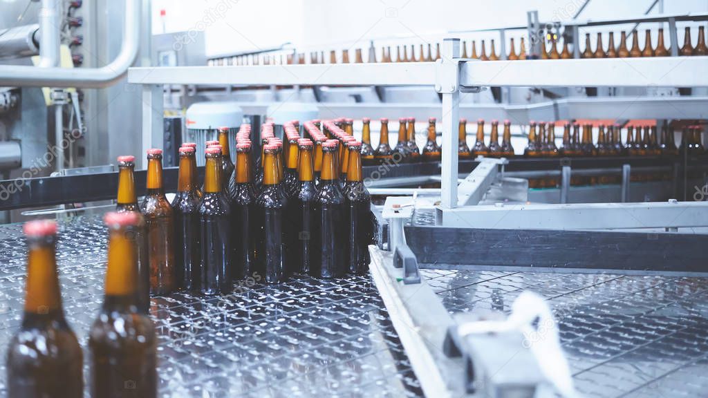 Beer bottles on the conveyor belt. Shallow dof. Selective focus.