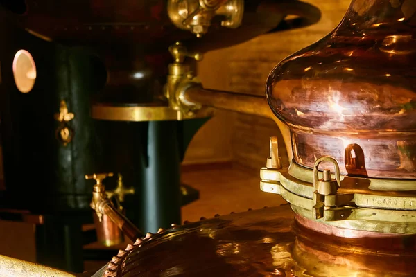 Detalis of medieval traditional distiller cube made from copper production of alcohol, cognac, whiskey. Fragment of copper old distiller for alcohol production. Ancient traditional food technologies