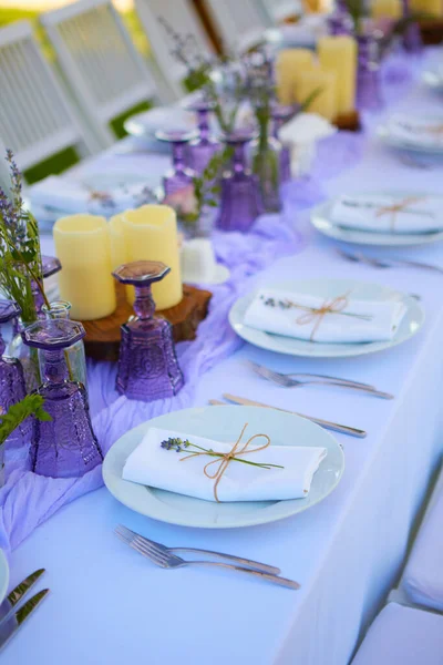 Elegant table setting for wedding engagement Easter dinner with white ceramic plates cotton napkin tied with twine lavender flowers candles. Provence style — Stock Photo, Image