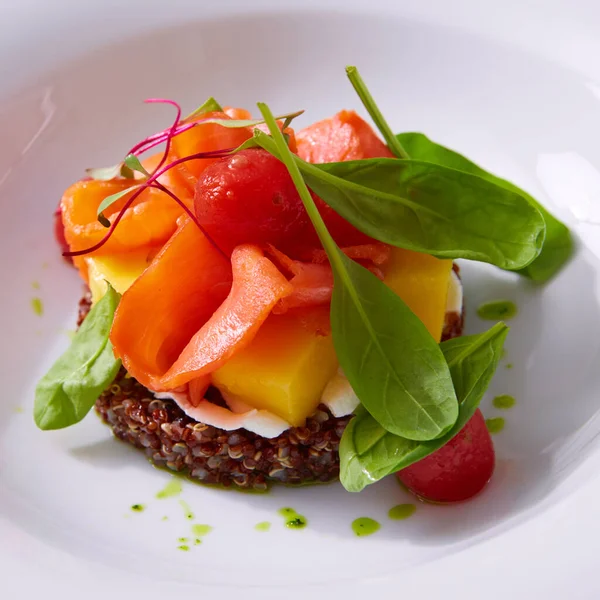 Delicate fillet of salmon on a cushion of quinoa with vegetables. Restaurant menu. White background. Free space for text. — Stock Photo, Image