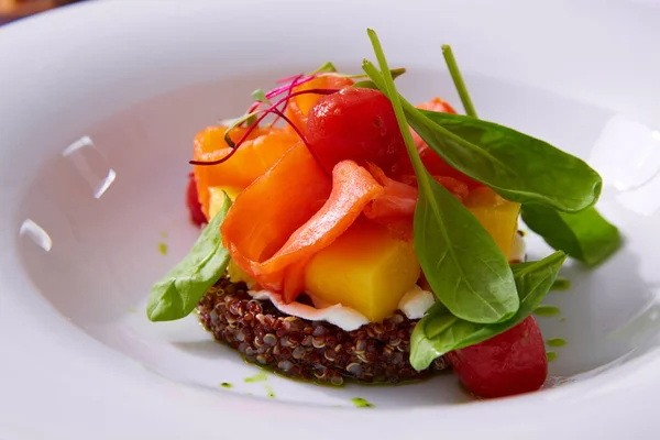 Delicate fillet of salmon on a cushion of quinoa with vegetables. Restaurant menu. White background. Free space for text. — Stock Photo, Image