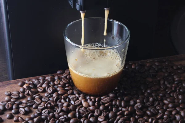 coffee glass coffee beans on a stone background a coffee machine