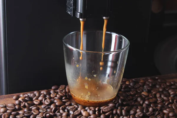 coffee glass coffee beans on a stone background a coffee machine