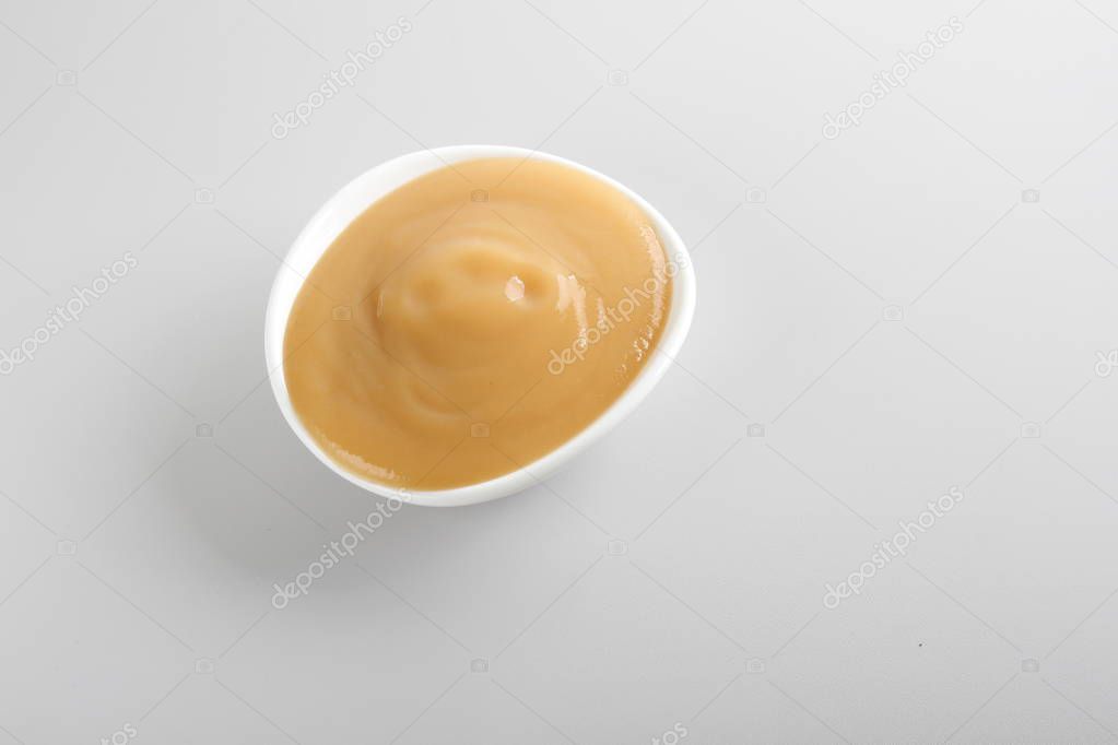 puree baby in a glass on a light background