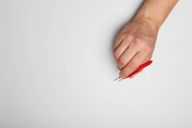 El hafif bir arka plan üzerinde kırmızı cımbız