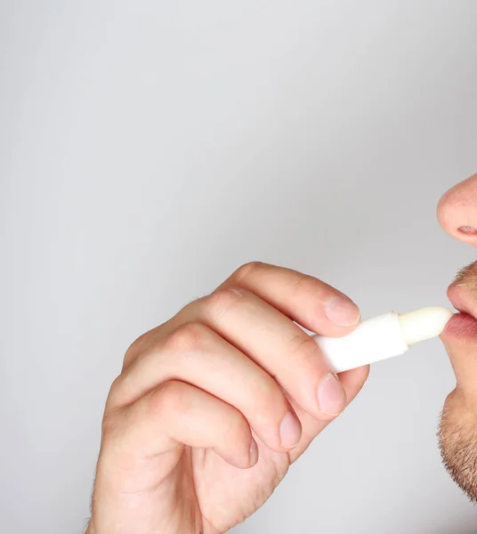 hygienic lipstick in a man's hand