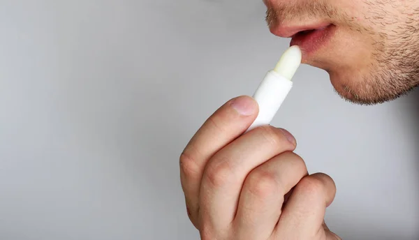 hygienic lipstick in a man\'s hand