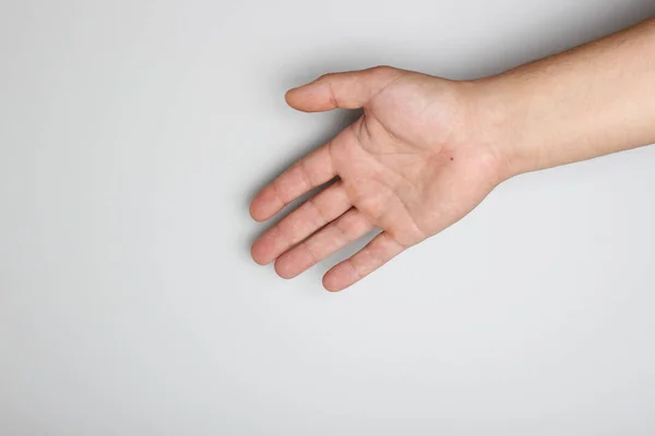 hand palm against a light gray background