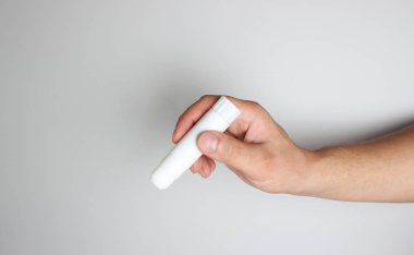 Glue Stick'i hafif bir arka plan üzerinde elinde