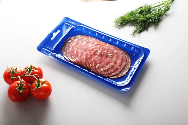 blue vacuum packing sausage cut on a light background