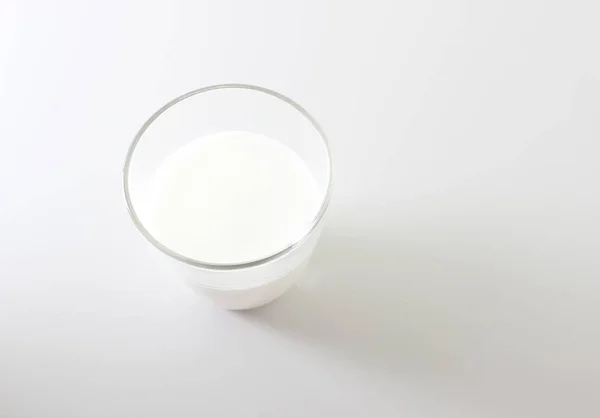 牛奶泡沫玻璃在轻的背景 — 图库照片