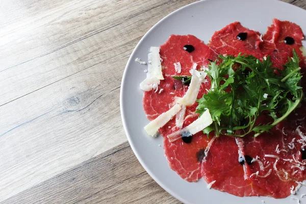 Carpaccio on a wooden background — Stock Photo, Image