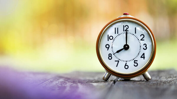 Time management concept - web banner of a retro orange alarm clock 