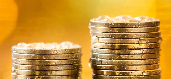 Gold investments, inflation concept, precious metal savings, stack of money coins. Web banner, golden business background.