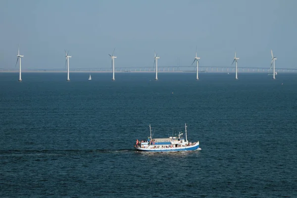 Sea, walking motor ship and wind generators. Copenhagen, Denmark