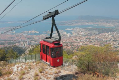 Cableway cabin over seaside city. Toulon, France clipart
