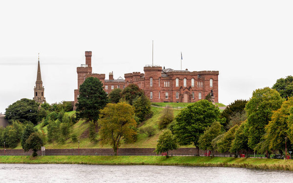 A beautiful castle on a hill overlooking river Ness in autumn season, Inverness, Scotland