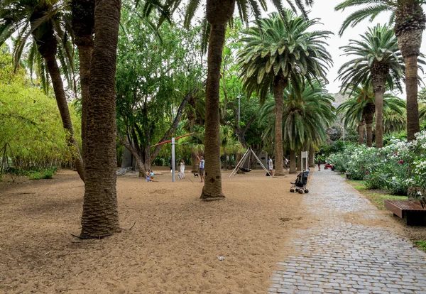 Un parco giochi per bambini vicino a una passerella lastricata attraverso il parco Garcia Sanabria a Santa Cruz de Tenerife, Isole Canarie, Spagna — Foto Stock