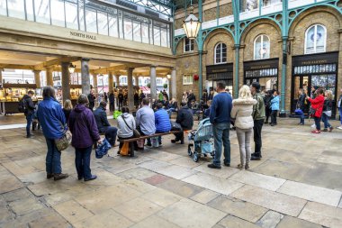 Turistler ve ziyaretçiler, İngiltere 'nin Londra kentindeki Covent Garden alışveriş bölgesinde bir sokak performansı izlediler.