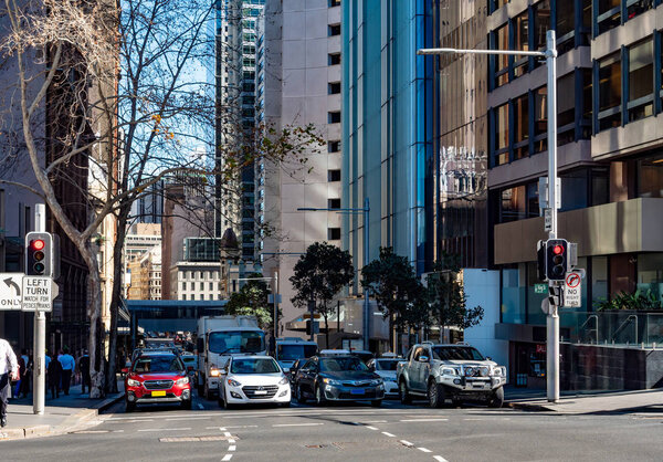 Four lanes of cars waiting at traffic lights in downtown Sydney