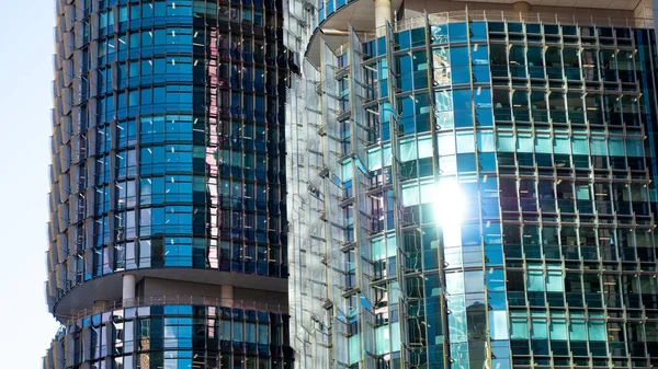 Closeup of sunny blue windows in round office buildings — Stock Photo, Image