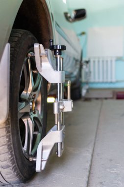 Tekerlekler hizalama kamber için gezici sensörleri ile stand arabayı kontrol servis istasyonu atölyesinde.