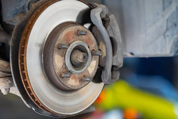 Yeni lastik değiştirme işlemi sırasında arabanın ön disk freni. Ön pervane ve kalibresini gösteren kenar sökülmüş.