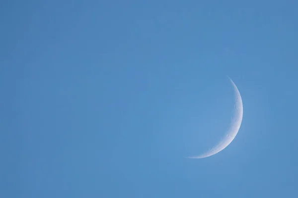 New Moon in the daytime on the day blue sky.