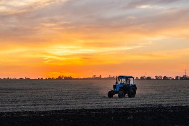 Altın Sunset'teki alanında iş yerine getiren ön planda Tarım makineleri.