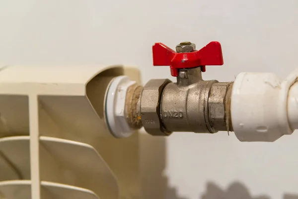 Water valve with red handle. Ball valve used in plumbing and heating systems. plumbing fittings.