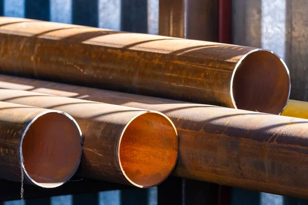 Stack of cylindrical round steel pipes. Industrial theme
