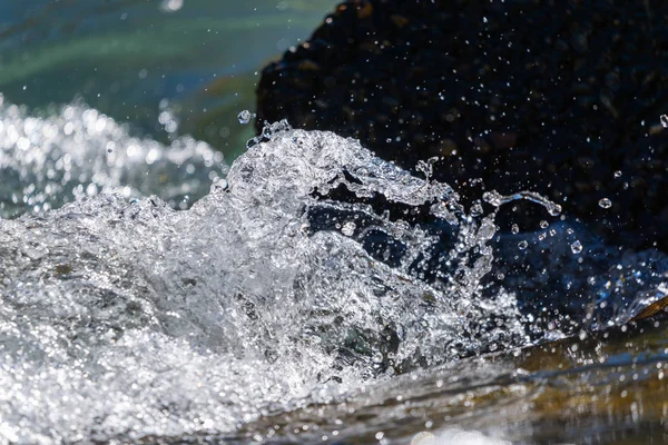 Water mountain river and the wonderful rocky creek. Water Drops after splash. Closeup macro view.