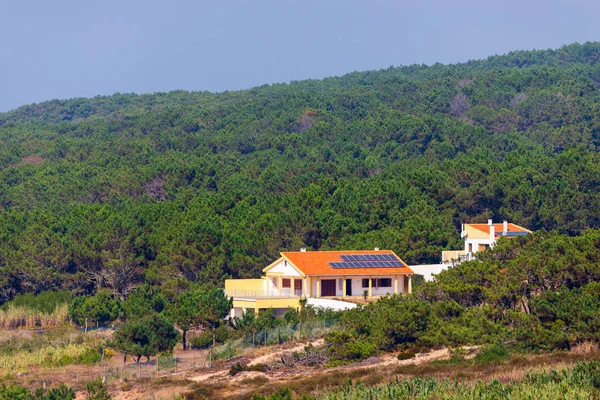 Alone House with garden and solar panels on the roof in nature