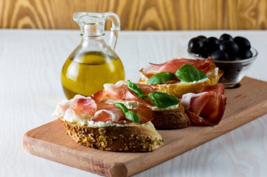 İtalyan domates, jambon, jamon, jambon ve peynir bruschetta. Tapas, antipasti Doğranmış sebzeler, otlar ve petrol ızgara ciabatta ve baget ekmek.