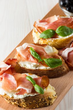 İtalyan domates, jambon, jamon, jambon ve peynir bruschetta. Tapas, antipasti Doğranmış sebzeler, otlar ve petrol ızgara ciabatta ve baget ekmek.