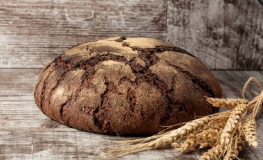 Retro bread in rustic style background.Fresh traditional bread on wooden ground with flour in a sack.