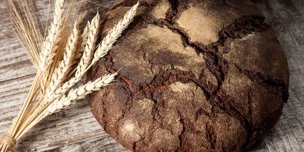 Retro bread in rustic style background.Fresh traditional bread on wooden ground with flour in a sack.